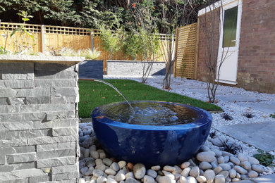 Inspiration for a small contemporary back full sun garden in Oxfordshire with natural stone paving.