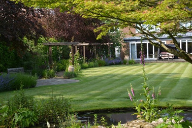Photo of a medium sized back garden in Hertfordshire.