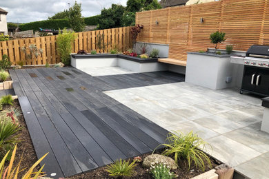 Design ideas for a medium sized modern back partial sun garden for summer in Cornwall with a raised bed and decking.