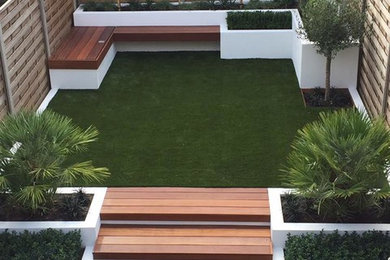 This is an example of a medium sized modern back formal garden in London.