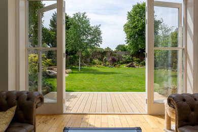 This is an example of a large classic back partial sun garden in London with decking.