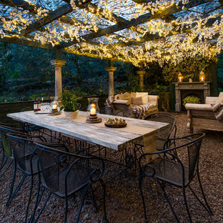 Design ideas for a mid-sized shabby-chic style backyard partial sun garden in Other with gravel.