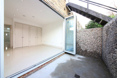 This is an example of a small modern back garden in London.