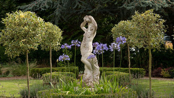 Central statue circled by holly standards and agapanthus