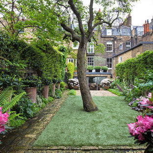 Inspiration for a classic back formal garden in London with brick paving.