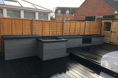 This is an example of a medium sized contemporary back garden in Kent with decking.