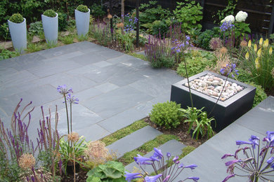 Small contemporary back partial sun garden for summer in Other with natural stone paving.