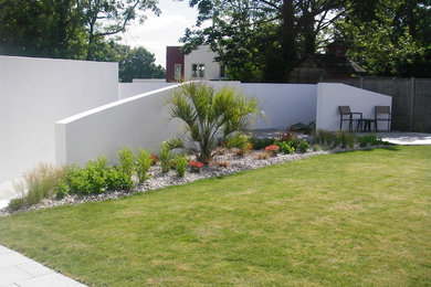 Inspiration for a medium sized contemporary back full sun garden in Hampshire with natural stone paving.