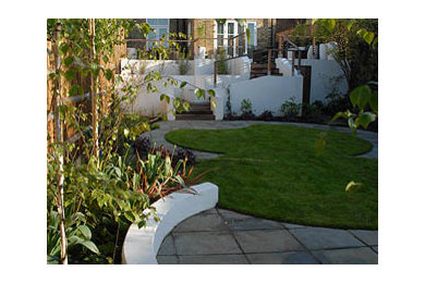 Inspiration pour un aménagement d'entrée ou allée de jardin arrière design de taille moyenne et l'été avec une exposition ensoleillée et des pavés en pierre naturelle.
