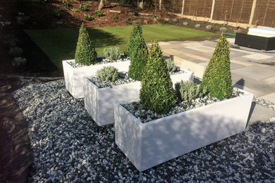 Inspiration for a medium sized contemporary back formal partial sun garden for summer in London with natural stone paving.