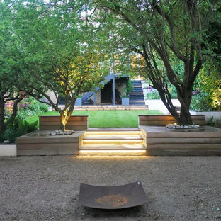 Inspiration for a contemporary back garden in London with a fire feature and gravel.