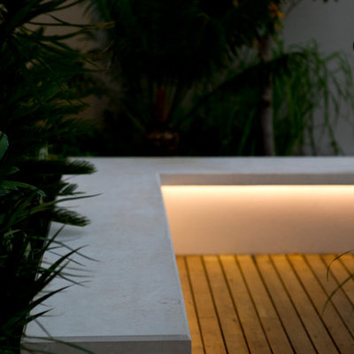 Design ideas for a small contemporary courtyard retaining wall landscape in Other with decking.