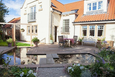 Diseño de jardín contemporáneo de tamaño medio en verano en patio trasero con jardín francés, estanque, exposición total al sol y adoquines de piedra natural