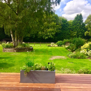 Classic back formal garden in London with a potted garden and decking.