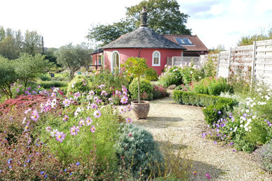 This is an example of a medium sized country garden in Other with a flowerbed.