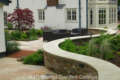 This is an example of a mid-sized farmhouse landscaping in Cheshire.