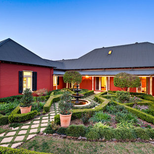 Design ideas for a country full sun formal garden in Sydney with a water feature and concrete pavers.