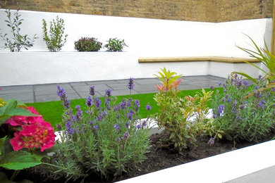 Contemporary garden in Other with natural stone paving.