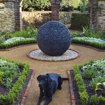 Dark Planet garden sculpture in traditional style courtyard