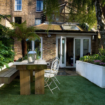 Decked bench and dining table on artificial lawn