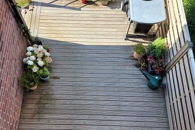 Inspiration for a medium sized back partial sun garden in Surrey with decking.