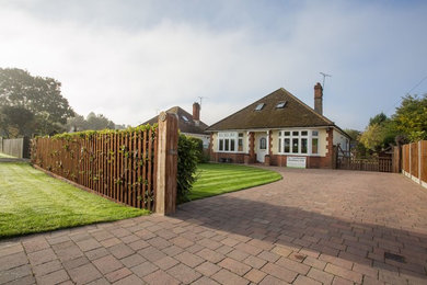 Photo of a medium sized modern front driveway partial sun garden in Buckinghamshire with a garden path and concrete paving.