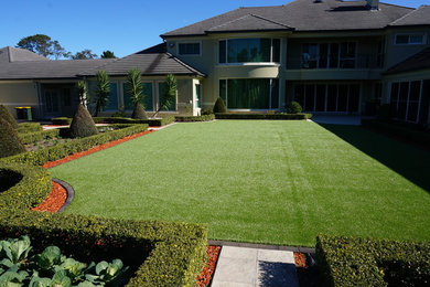 Inspiration for an expansive modern front formal garden in Sydney with a garden path.