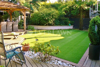 Medium sized modern back formal partial sun garden in Other with decking.