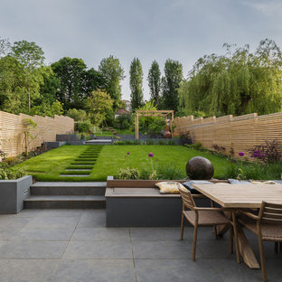 This is an example of a large contemporary back full sun garden in London.