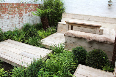 Design ideas for a small eclectic back partial sun garden in Other with a garden path and decking.