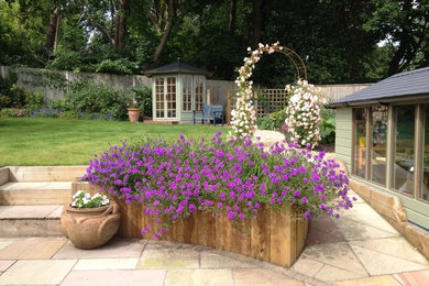 Rural garden in Hampshire with a raised bed.