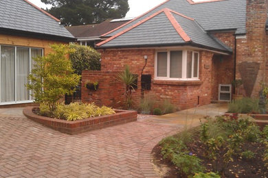 Traditional front garden in Hampshire with a garden path.