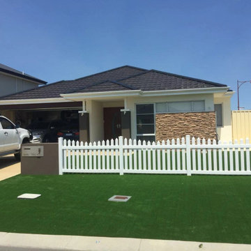 Front Yard Perfected by Synthetic Grass around/through White Picket Fence