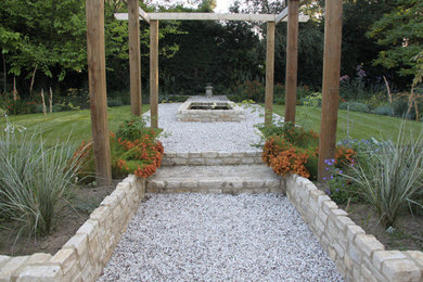 На фото: большой тенистый, летний садовый фонтан на боковом дворе в классическом стиле