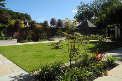 Inspiration for a medium sized contemporary back formal fully shaded garden in Other with natural stone paving.