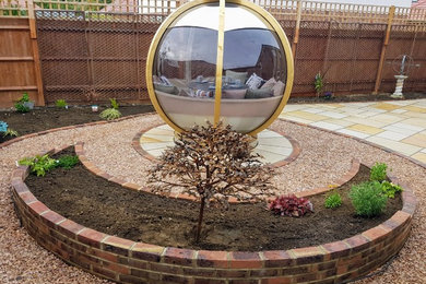 Photo of a small contemporary back formal partial sun garden for summer in Sussex with brick paving.