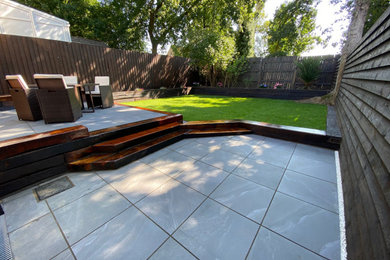 Inspiration for a large modern back formal partial sun garden for summer in Devon with a retaining wall.