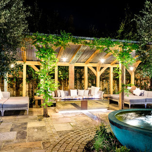 Inspiration for a large farmhouse courtyard formal full sun garden for summer in Sussex with natural stone paving and a water feature.