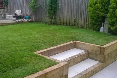 This is an example of a medium sized modern back garden in Hampshire.
