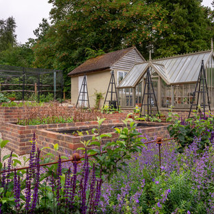 Design ideas for a classic back formal garden in Surrey with a potted garden and gravel.