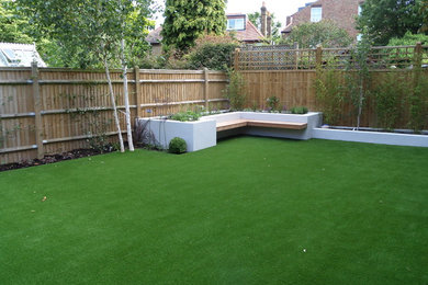Design ideas for a contemporary back partial sun garden in London.