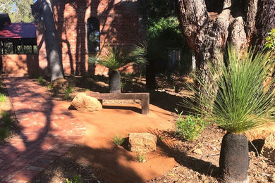 Medium sized rural front xeriscape partial sun garden in Perth with a garden path and brick paving.