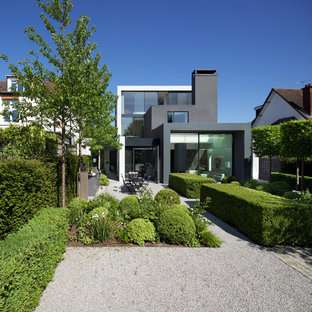 Design ideas for a contemporary back formal full sun garden in London with a garden path and gravel.