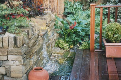 Medium sized contemporary back garden in Devon with a water feature.