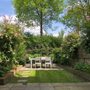 Classic back garden in London with concrete paving.