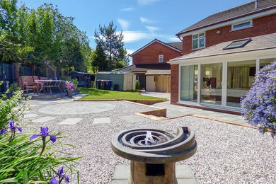 Photo of a modern courtyard driveway full sun garden for spring in Other with a water feature and natural stone paving.