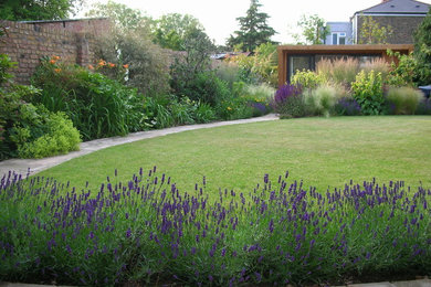 Contemporary garden for summer in London with natural stone paving.