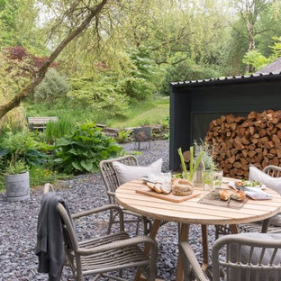 Photo of a medium sized rustic back garden in Other with gravel.
