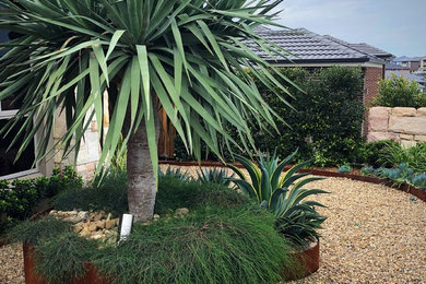 Idee per un grande giardino xeriscape minimalista esposto in pieno sole davanti casa con un ingresso o sentiero e ghiaia