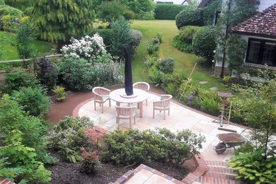 Traditional back garden in Sussex with natural stone paving.